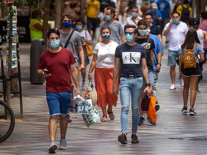 Varias personas con mascarilla pasean por el centro de Madrid, este martes.