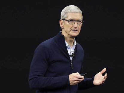 FILE- In this Sept. 12, 2017, file photo, Apple CEO Tim Cook, shows new Apple Watch Series 3 product at the Steve Jobs Theater on the new Apple campus in Cupertino, Calif. Cook is leaving shareholders in suspense about whether the iPhone maker will use its windfall from a tax cut on overseas profits for a big boost to its quarterly dividend. (AP Photo/Marcio Jose Sanchez, File)