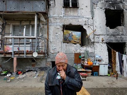 Local resident Galina Shevtsova reacts outside the apartment building where she lives in the basement with her husband Pavel after their flat was destroyed in March 2022 in the course of Russia-Ukraine conflict, in Mariupol, Russian-controlled Ukraine, November 16, 2022. REUTERS/Alexander Ermochenko     TPX IMAGES OF THE DAY
