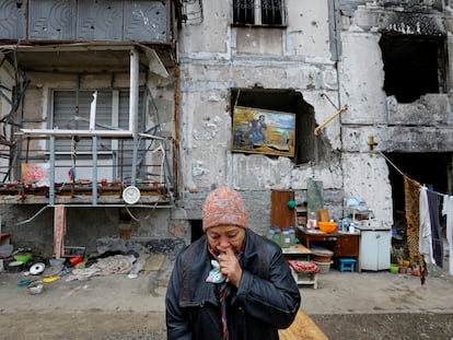 Local resident Galina Shevtsova reacts outside the apartment building where she lives in the basement with her husband Pavel after their flat was destroyed in March 2022 in the course of Russia-Ukraine conflict, in Mariupol, Russian-controlled Ukraine, November 16, 2022. REUTERS/Alexander Ermochenko     TPX IMAGES OF THE DAY