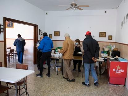 Una cocinera sirve comida en el comedor de Cáritas en Jaén, en 2022.