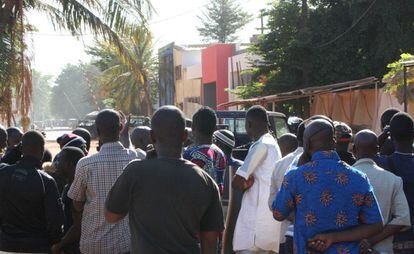 Entre las 170 personas secuestradas en el hotel Radisson Blu de Bamako, la capital de Malí, figuran ciudadanos de nacionalidad francesa y china y empleados de la compañía Turkish Airlines. En la imagen, un grupo de personas en el exterior del hotel en Bamako.