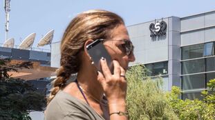 Una mujer usa su teléfono móvil frente al edificio de la empresa israelí NSO Group, desarrolladora del 'software' espía Pegasus, en Tel Aviv.