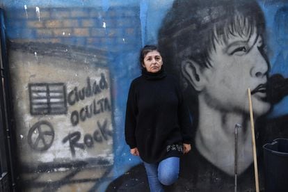Bilma Ibarra poses in front of one of the murals decorating her En-Haccore communal dining room in Ciudad Oculta, Buenos Aires, June 11, 2022.