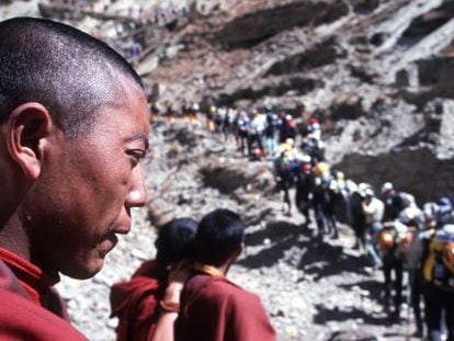 Monjes tibetanos observan una carrera de deportes de aventura.