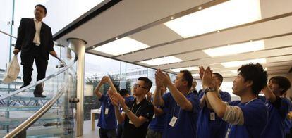 Empleados de la tienda aplauden a la primera persona que compró un nuevo iPad en una tienda de Apple en Hong Kong, 16 de marzo 2012.
