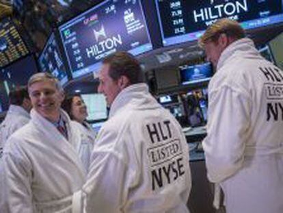 Directivos de Hilton posan en albornoz en el parqu&eacute; de Wall Street en el estreno en Bolsa de la cadena hotelera.