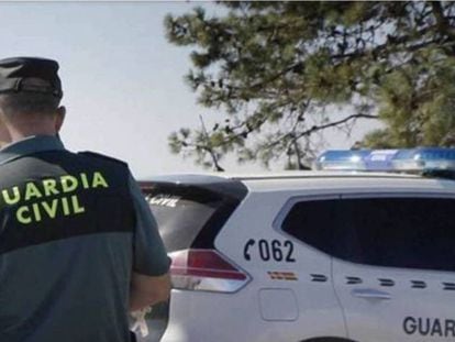 Un guardia civil delante de un coche patrulla, en una imagen de archivo. En vídeo, la tortura a la que fue sometido uno de los traficantes.