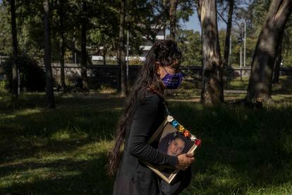 Aracely Osorio, mother of Lesvy Berlin Osorio, walks with a photograph of her daughter in the gardens where her body was found, inside the National Autonomous University of Mexico. 