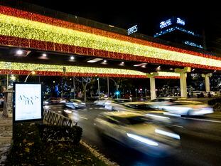 Luces de Navidad de Madrid con los colores de la bandera de España en el Puente Juan Bravo, en el primer día de encendido de las luces de Navidad.