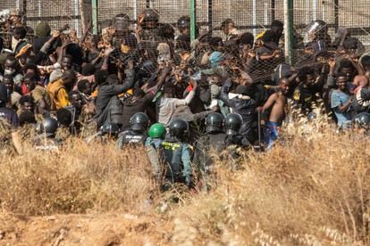 Dozens of migrants pass through the Melilla fence that separates Morocco from Spain. 
