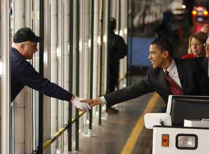 El aspirante demócrata Barack Obama saluda a un trabajador en su visita a una planta de General Motors, ayer, en Wisconsin.