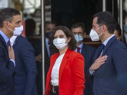 Isabel Díaz Ayuso, presidenta de la Comunidad de Madrid, flanqueada por el presidente del Gobierno, Pedro Sánchez (a la izquierda), y el vicepresidente de la Comunidad, Ignacio Aguado, el lunes.