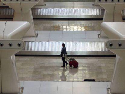 Una viajera en el área de recogida de equipajes de la terminal 4 de Madrid-Barajas.