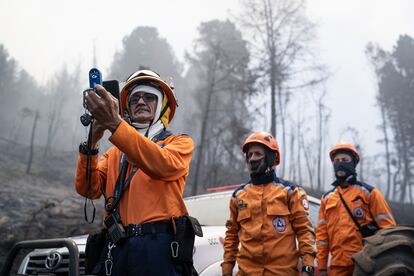 Members of the Colombian Civil Guard measure wind speed, humidity and temperature at the top of the mountain. 