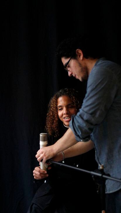 El pianista Luis Guerra le ajusta el micrófono a Danays Bautista antes de interpretar las primeras canciones.