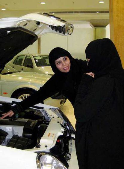 Dos mujeres observan un coche en un establecimiento de Riad.