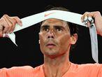 Spain's Rafael Nadal adjusts his headband while playing against Greece's Stefanos Tsitsipas during their men's singles quarter-final match on day ten of the Australian Open tennis tournament in Melbourne on February 17, 2021. (Photo by William WEST / AFP) / -- IMAGE RESTRICTED TO EDITORIAL USE - STRICTLY NO COMMERCIAL USE --