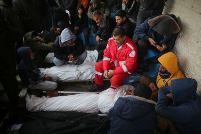 A Palestinian Red Crescent doctor cries at a funeral in Deir al Balah, central Gaza, on January 22, 2024.