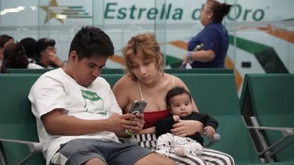 Una familia busca autobuses tras ser desalojados de Acapulco por el huracán. 