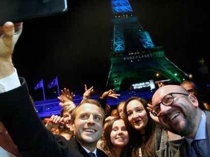 Macron posa para un selfi con el primer ministro belga, Charles Michel, rodeados de jóvenes tras el One Planet Summit de París el 12 de diciembre.