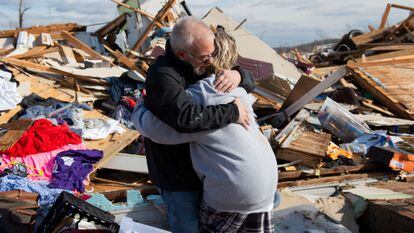 Mike Castle hugs his daughter after a tornado hit in Kentucky last December.