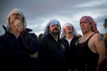 Costaleros de la hermandad de "La Estrella" esperan su turno para llevar sobre sus espaldas el paso de Cristo durante la procesión del Domingo de Ramos en Sevilla, 24 de marzo 2013.