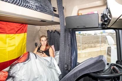 María Delgado, in the bed that she has installed in the cabin of her truck.
