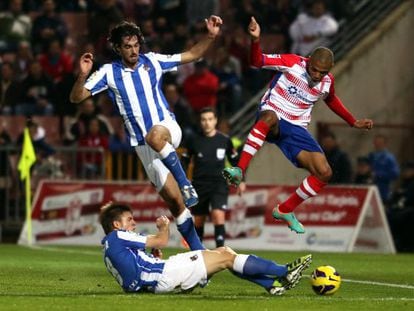 Carlos Mart&iacute;nez salta sobre Illarramendi en el partido de la Real contra el Granada.