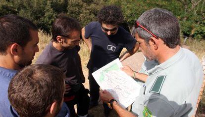 Bomberos y forestales, ayer, en Terrades controlando los últimos focos del incendio.