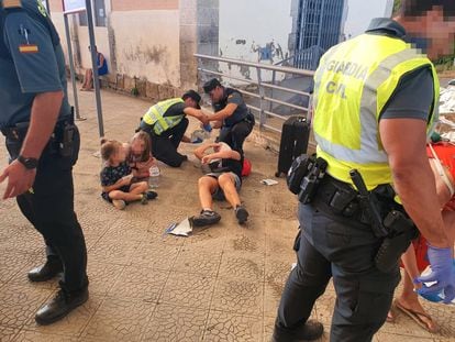 Varios agentes atienden a pasajeros heridos en la estación de Caudiel (Castellón), nada más llegar el tren. Al fondo, uno de los quemados.