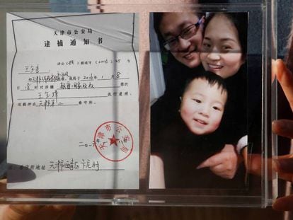 Li Wenzu, esposa del abogado Wang Quanzhang, sostiene una foto de familia, el pasado 17 de diciembre en Pekín. En vídeo, Amnistía Internacional critica la condena.
