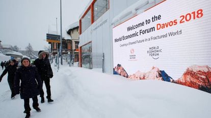 Varias personas pasan ante el centro de convenciones donde se celebra el Foro Económico en Davos.