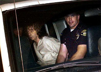 Phil Spector, acompañado de un policía de Los Ángeles tras su detención. A la izquierda, la actriz Lana Clarkson.