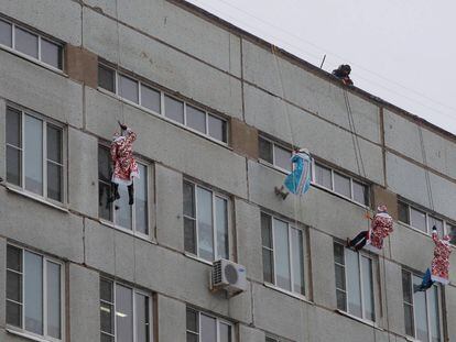 Bomberos rusos vestidos de 'Ded Moroz', el Papá Noel ruso, trepan por la fachada del hospital pediátrico Morozovskaya, en Moscú (Rusia) 