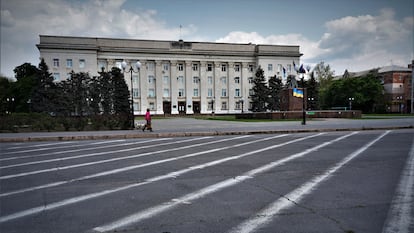 A woman in the deserted streets of downtown Kherson.
