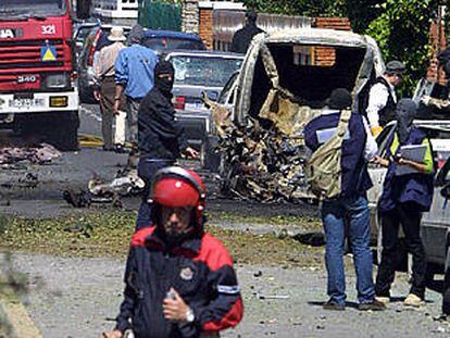 La policía vasca examina el lugar donde la banda terrorista ETA explosionó ayer un coche bomba.