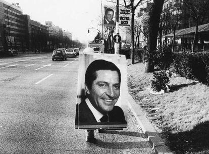 Un operario transporta por el Paseo de la Castella en Madrid un cartel electoral de Adolfo Suárez (1979).
