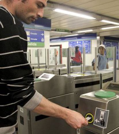 Un usuario introduce su billete en el torno de entrada de una estación del metro de Madrid.