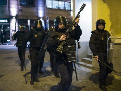 Un policía nacional porta una escopeta preparada para disparar pelotas de goma en una manifestación celebrada en Madrid en 2014.