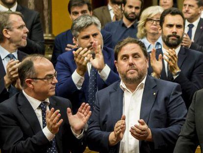 El presidente de la Generalitat, Carles Puigdemont (c) tras su discurso ante el pleno del Parlament donde esta tarde compareció para explicar la situación política.