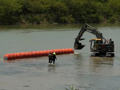 Trabajadores colocan una barrera flotante en el río Bravo, en la frontera con Piedras Negras (Coahuila), el 11 de julio.