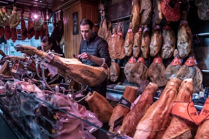 Un empleado corta jamón en una charcutería de Valencia.