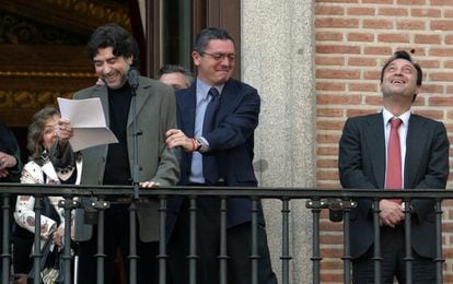 De izquierda a derecha, Joaquín Sabina lee el pregón de las fiestas de San Isidro desde un balcón de la plaza de la Villa el 13 de mayo de 2005 en presencia del alcalde, Alberto Ruiz-Gallardón, y el vicealcalde, Manuel Cobo.
