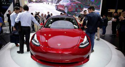 FILE PHOTO: A Tesla Model 3 car is displayed during a media preview at the Auto China 2018 motor show in Beijing