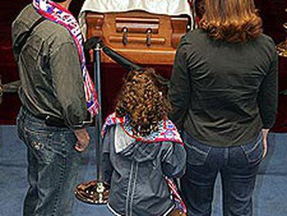 Aficionados del Atlético ante el féretro de Jesús Gil en la capilla ardiente instalada en el Vicente Calderón.
/ BERNARDO PÉREZ