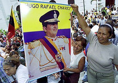 Simpatizantes de Hugo Chávez muestran un cartel con su fotografía en una calle de Caracas.