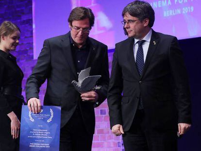 A la foto, Puigdemont (dreta), després de lliurar el premi a Álvaro Longoria. En vídeo, tràiler del documental 'Dues Catalunyes'.