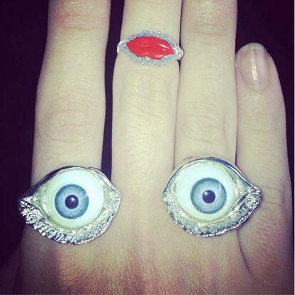 Kelly decora su mano en forma de cara con anillos en forma de ojos y labios.