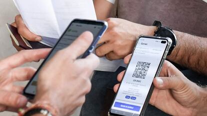 Dos usuarios muestran su pasaporte covid antes de acceder en un cine de París.